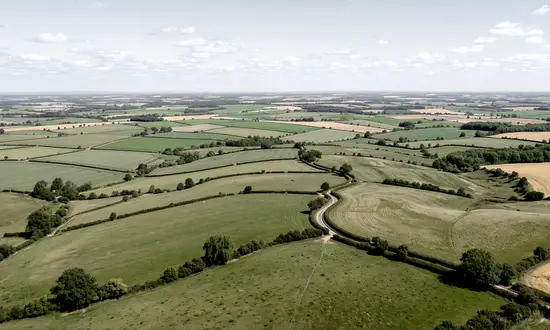 A wind turbine on your land could be worth far more than a small on-farm installation – but only if the full range of options is understood before a decision is made. Often the idea of wind energy creates a mental image of a single turbine covering electricity costs. For landowners whose sites clear the considerable hurdles onshore wind development imposes, that mental image is worth examining carefully.